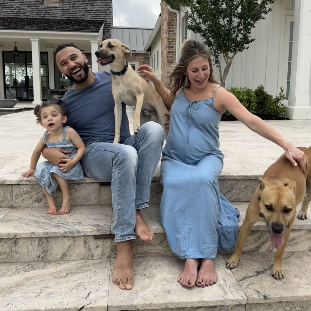 Coach John Marshall and his family posed on a set of stairs for a busy family photo full of laughter.